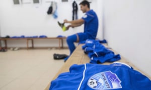 A player from the Aroni Ariel football club prepares in the locker room for training session at their stadium in the Israeli West Bank settlement of Ariel.