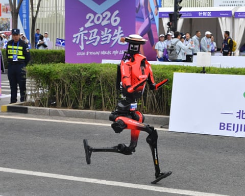 A red humanoid robot running