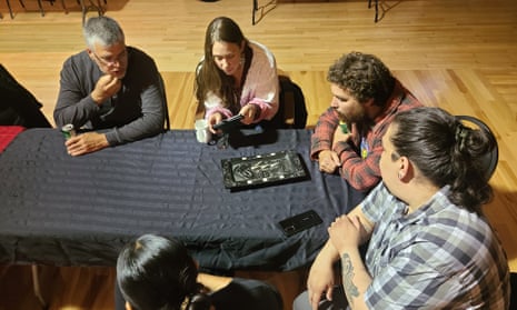 Members of the Haida nation examine a carved argillite platter that has been returned to their home in Haida Gwaii by Buxton museum in Derbyshire.