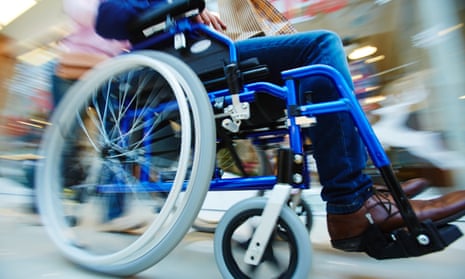A man in a wheelchair being pushed