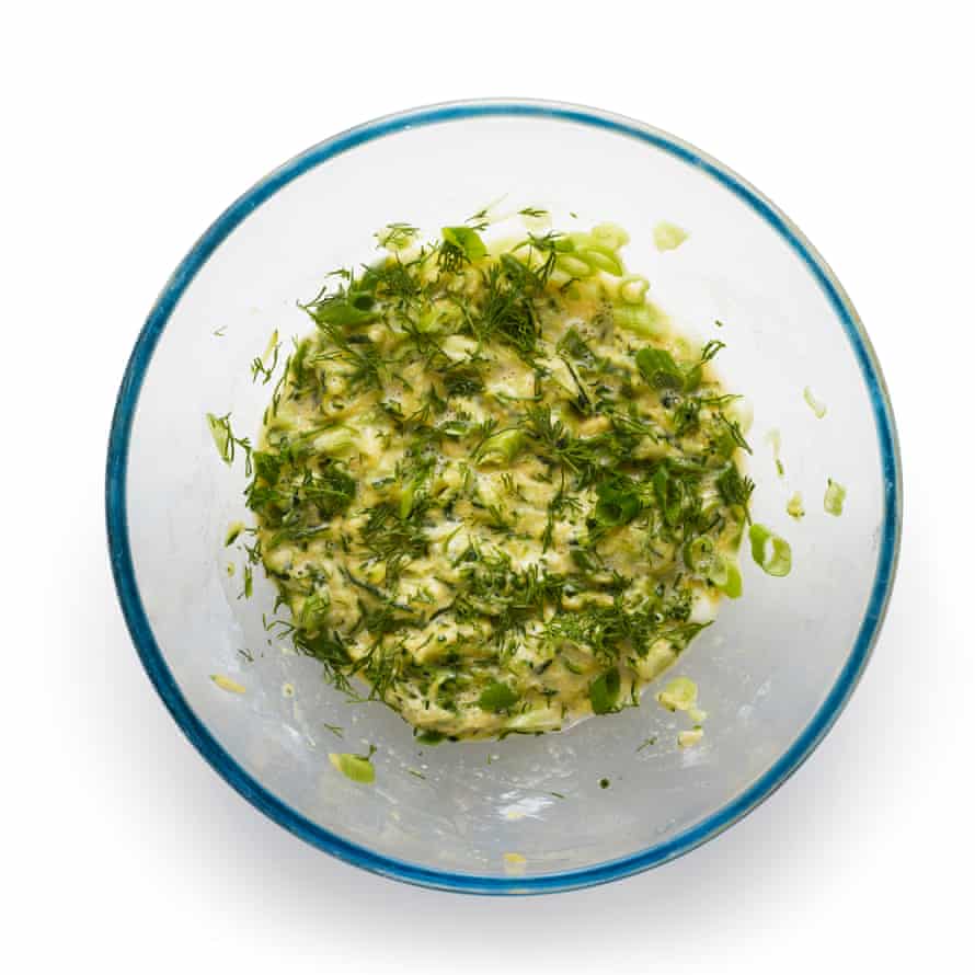 Felicity Cloake’s courgette fritters 5: adding feta and herbs.