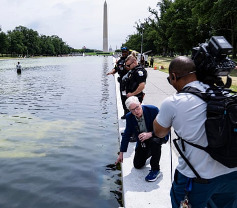 A TV news crew reported on the floating pieces of liner in the Lincoln Memorial reflecting pool on 19 June, as police examined algae in the water.