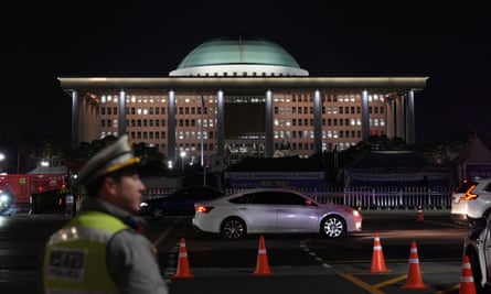 Police patrol near the national assembly as a rally demanding South Korean President Yoon Suk Yeol’s impeachment is taking place in Seoul on Tuesday night.