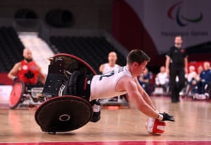 Britain’s Jamie Stead falls to the floor after being tackled in a wheelchair rugby match against Canada