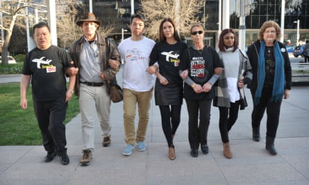 Gibson, second from left, with relatives of passengers on MH370 including Grace Subathirai Nathan, second from right, after a meeting in Canberra, Australia.