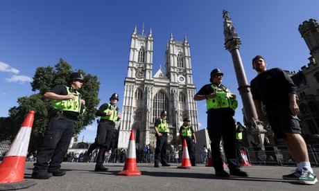 Police officers keep watch outside Westminster Abbey in London ahead Queen Elizabeth II's funeral