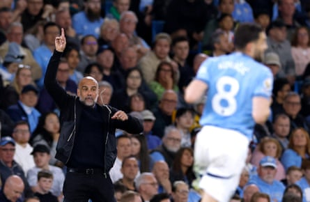 Pep Guardiola gesticulates and shouts instructions to his players