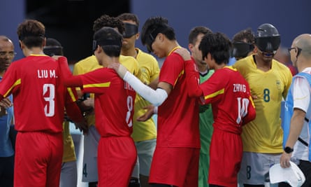China and Brazil players embrace after the final whistle.
