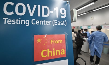 Health workers guide travellers arriving from China at a Covid-19 testing centre at Incheon International airport, Seoul, South Korea