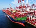 A cargo ship is loaded and unloaded with containers.