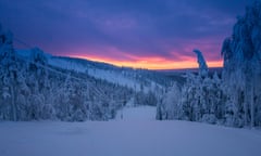 Moody sky with sunset over an ice and snow landscape in Finland.