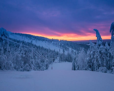 Moody sky with sunset over an ice and snow landscape in Finland.