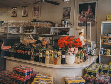 An overflowing deli counter with workers in food service clothes.