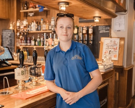 Morgan Philp in front of a bar in a blue polo top
