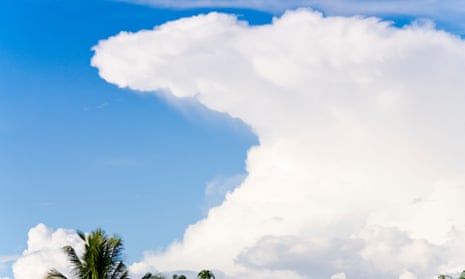 An anvil-shaped cumulonimbus cloud surrounded by blue sky.