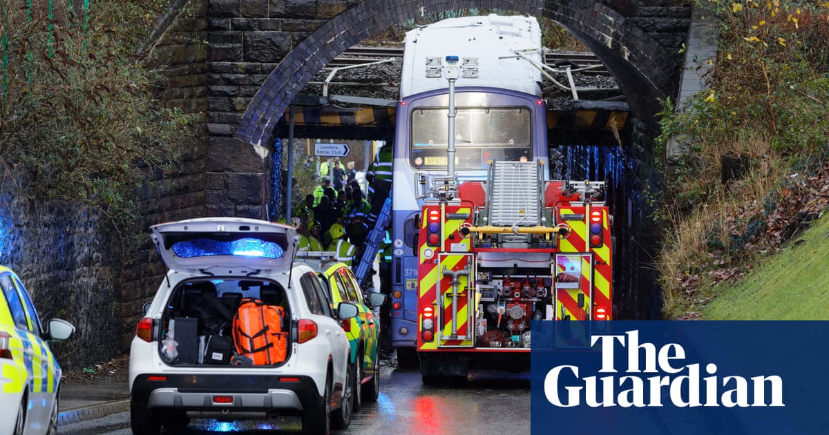 Double-decker bus crashes into railway bridge in Swansea