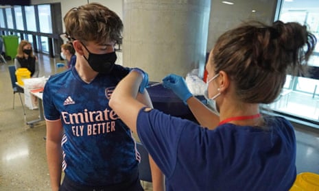 An 18-year-old boy is vaccinated at Tottenham Hotspur’s stadium in London.