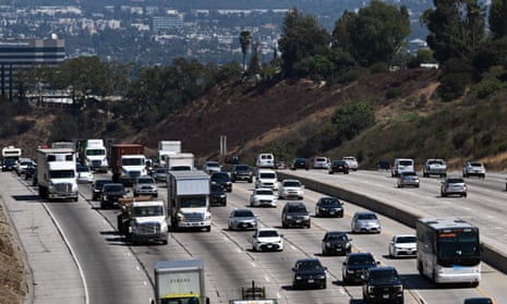 SUVs and other vehicles drive along the 405 freeway in Los Angeles, California.