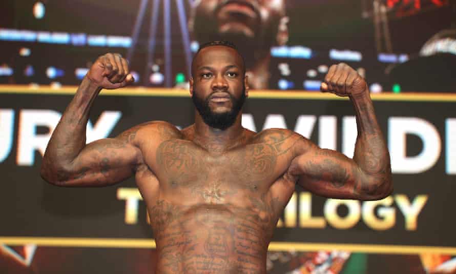 Deontay Wilder stands on the scale at the scale.