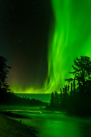 Mistlike aurora appears to rise from river