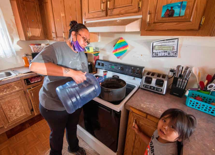 Amanda Larson, who has no running water at her home, carries water for her son Gary Jr to have a bath in the Navajo Nation town of Thoreau in New Mexico last year.