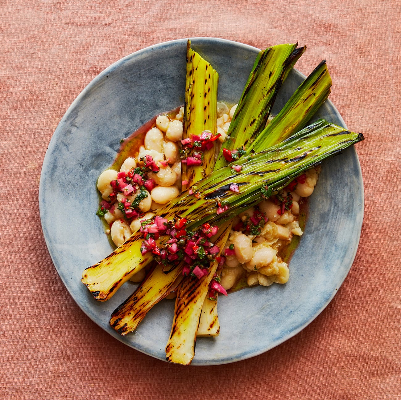 Thomasina Miers' griddled leeks, creamy white beans with a caper and mint relish.