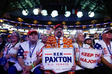 Blake Marnell, wearing a suit jacket with bricks representing a border wall, listens to Donald Trump in Dallas.