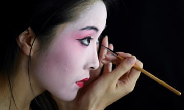 A model puts on makeup backstage during China fashion week