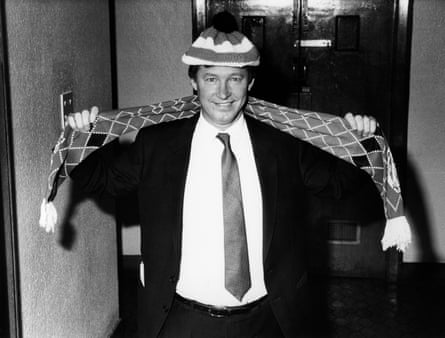 Alex Ferguson shows off the team hat and scarf after his appointment as Manchester United manager in November 1986