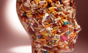 Head made of glass, in profile, filled with pills and capsules