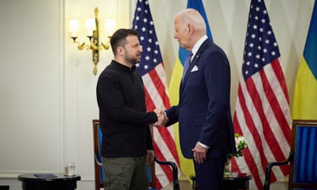 Volodymyr Zelenskiy and Joe Biden shake hands