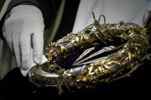A priest wipes the Crown of Thorns, a relic of the passion of Christ- at the Notre-Dame Cathedral in Paris.