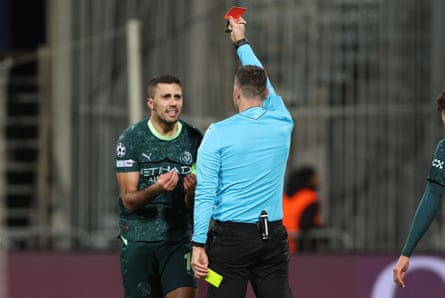 Rodri gestures at the referee to protest against being shown the red card