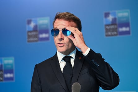 Emmanuel Macron wearing blue-tinted reflective sunglasses