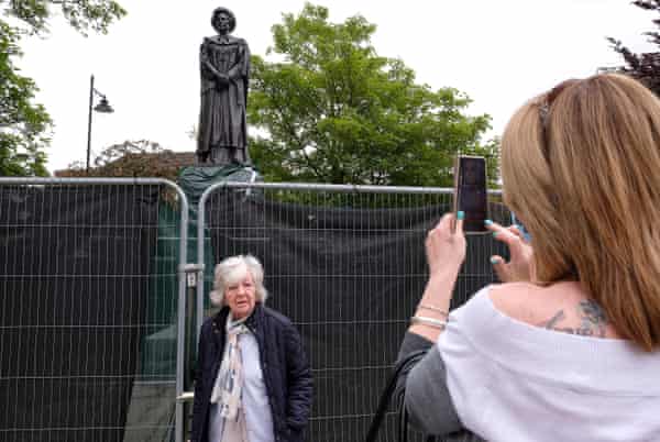Joy Brown posing for Pictures next to her statue in Hill of Saint Peter