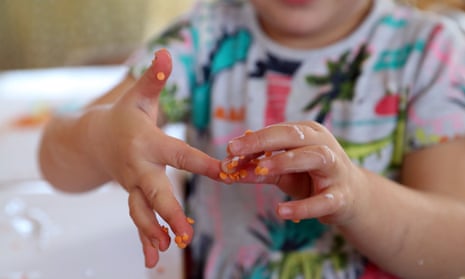 A child at Tops Day in Christchurch, Bournemouth, uses lentils and rice to make pictures after the use of glitter was banned.