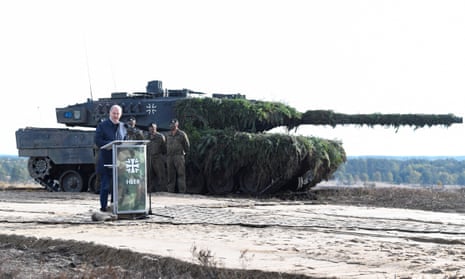 The German chancellor, Olaf Scholz, addresses soldiers in front of a Leopard 2 battle tank in October 2022.