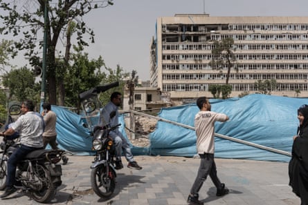 People in front on a damaged building