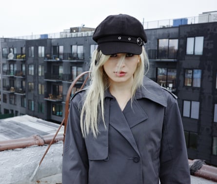 April Grey AKA Underscores wearing a grey coat and black cap.