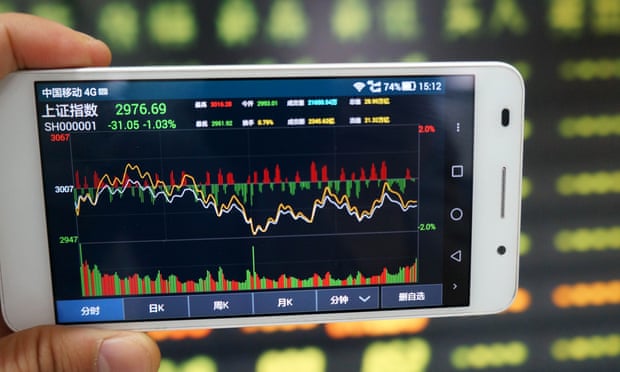 An investor shows the Shanghai Composite Index on his smartphone