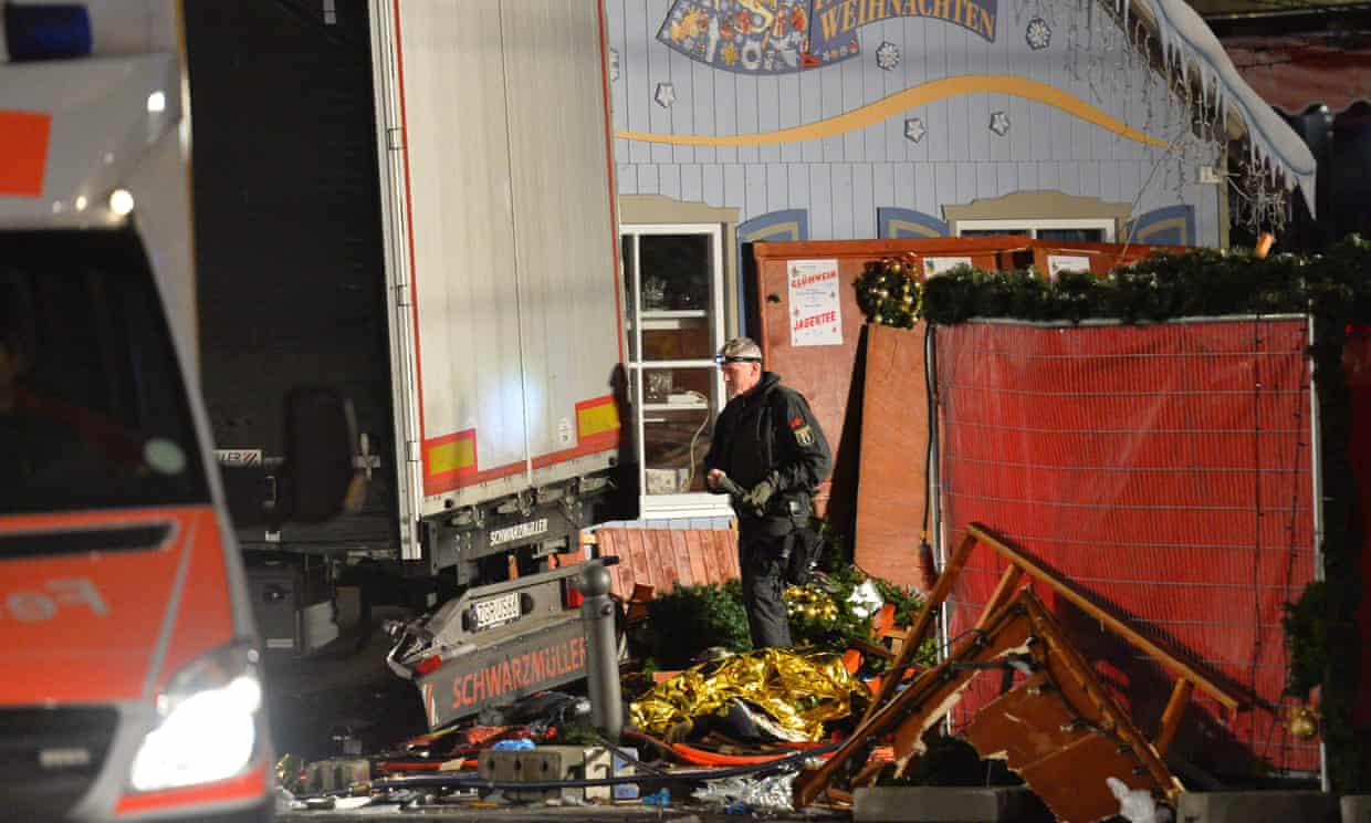A policeman inspects the truck that crashed into a Christmas market in Berlin.