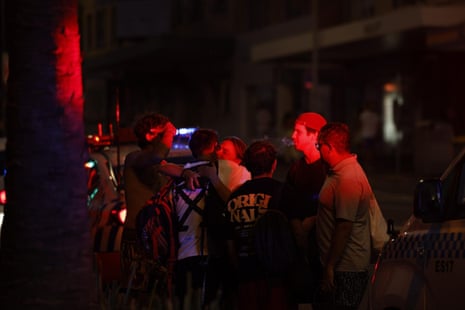 People comforting each other after a shooting at Bondi Beach, NSW, Australia.