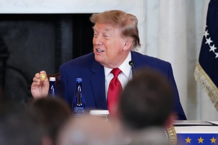 Donald Trump holds up a gold replica of a deep sea nodule given to him at a mining industry event earlier this month.