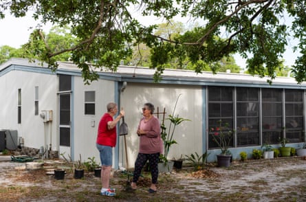 Two women talking outside a mobile home