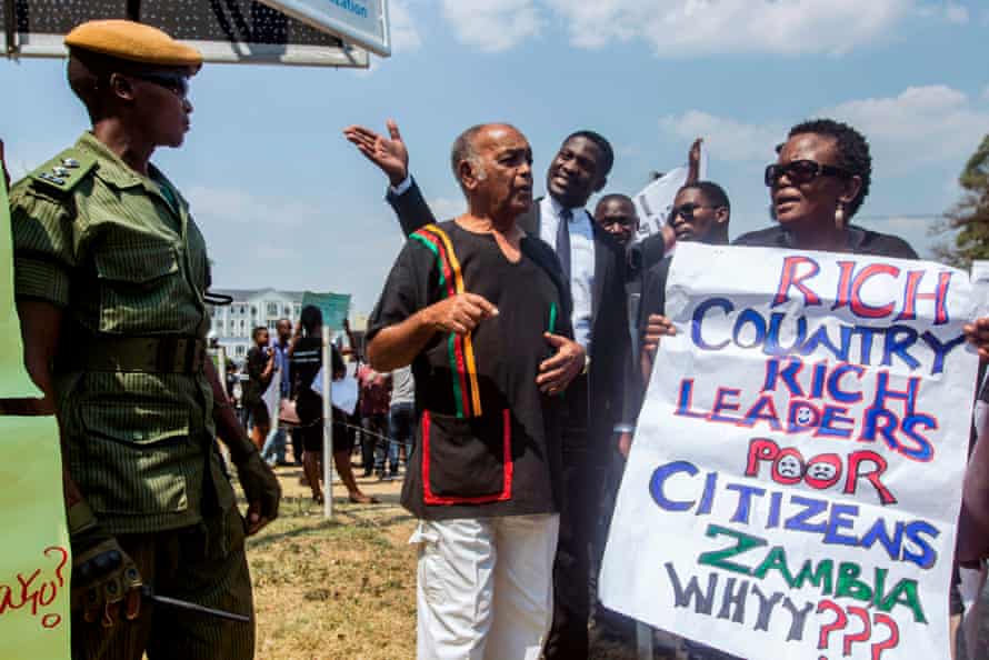 Laura Miti holds a placard during a protest against corruption.