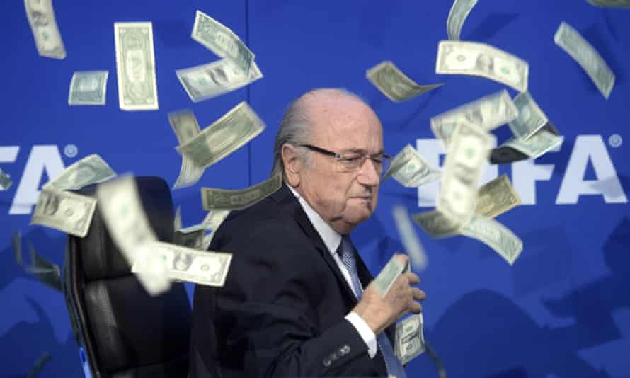 Sepp Blatter has banknotes thrown at him by comedian Simon Brodkin during a FIFA press conference in Switzerland in 2015
