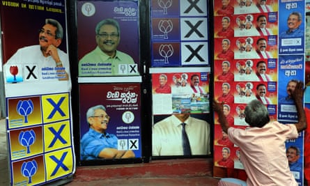 A supporter hangs posters of SLPP presidential candidate and former defence secretary Gotabhaya Rajapaksa.