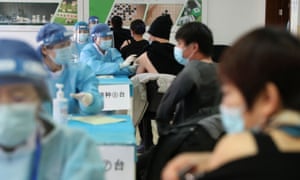 Coronavirus live news: half a million under lockdown in Beijing; new curbs as Malaysia hits 'breaking point' | World news 2 Medical workers administering the Covid-19 vaccine at a makeshift vaccination site in Beijing last week.