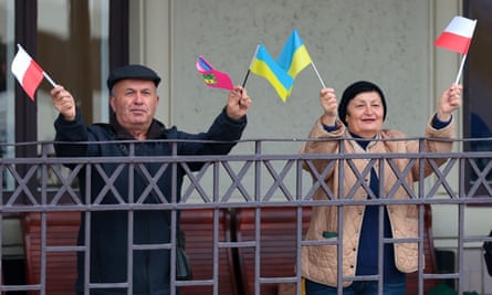 Man and woman wave little flags