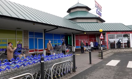 People queue outside a Tesco store in Dundee
